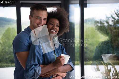 Image of romantic happy young couple relax at modern home indoors