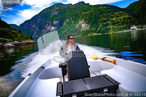 Image of Woman driving a motor boat