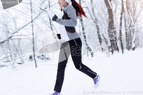 Image of Young woman running in morning