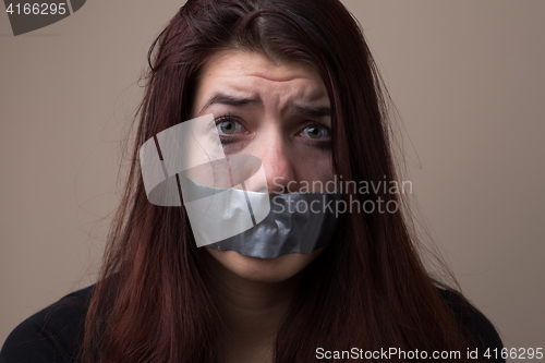 Image of Crying brunette with gray tape