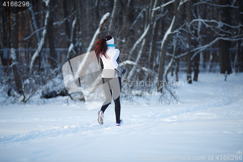 Image of Young girl running among trees