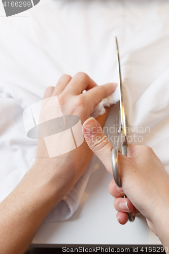 Image of Woman tailors with scissors fabric