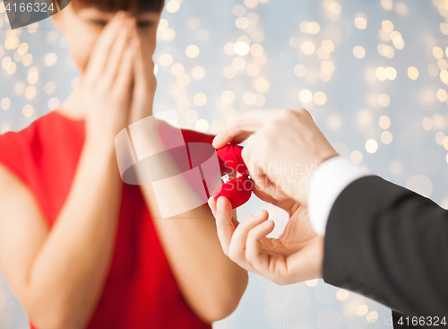 Image of close up of woman and man with engagement ring