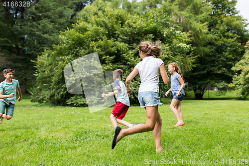 Image of group of happy kids or friends playing outdoors