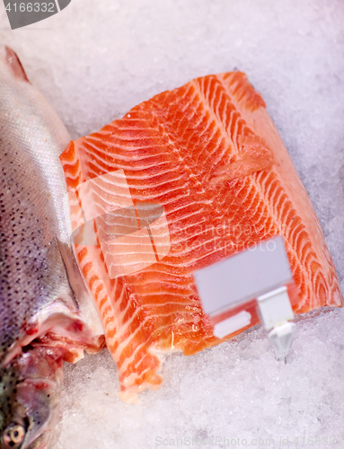 Image of salmon fish fillet on ice at grocery