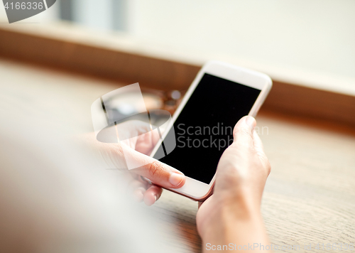 Image of close up of woman texting on smartphone