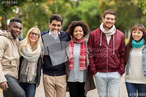 Image of group of happy international friends at park