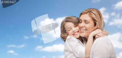 Image of happy mother and daughter hugging over blue sky