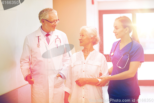 Image of medics and senior patient woman at hospital