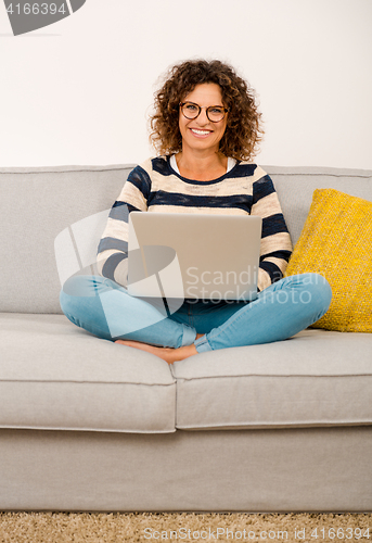 Image of Beautiful woman working at home