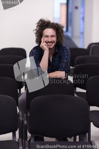 Image of A student sits alone  in a classroom