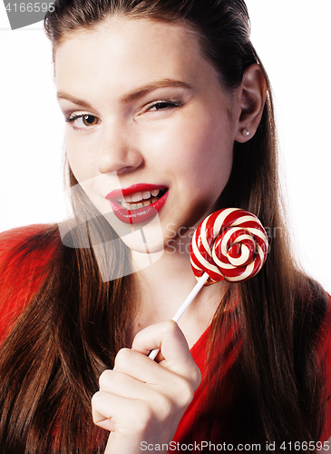 Image of young pretty brunette girl with red candy posing on white background isolated 