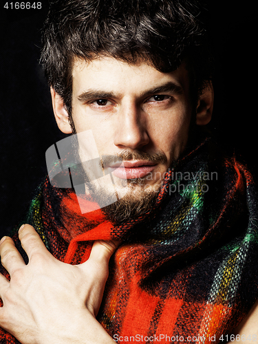 Image of portrait of handsome man warmed up in scarf christmas colored