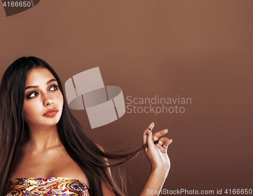 Image of cute happy young indian woman in studio close up smiling, fashion mulatto