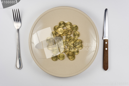 Image of On the plate is a bunch of Russian ten-coin lying near tableware view from above