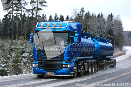 Image of Blue Scania R580 Tank Truck Hauling on Rural Winter Highway