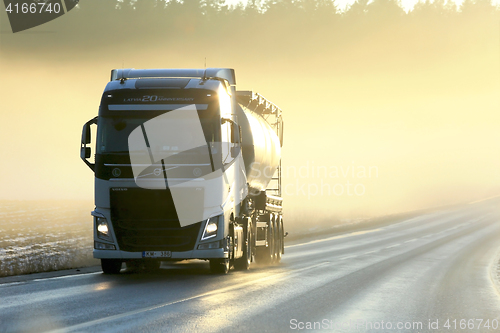 Image of Volvo Semi Tanker Trucking in Sunset Fog
