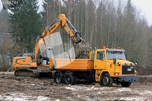 Image of Liebherr Crawler Excavator Loads Sisu SR332 Tip Lorry