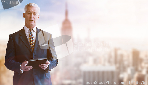 Image of Portrait of smiling senior businessman