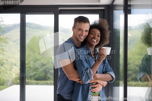 Image of romantic happy young couple relax at modern home indoors