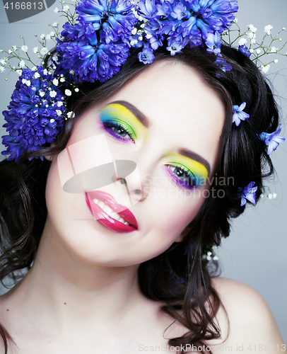 Image of Beauty young woman with flowers and make up close up, real spring beauty