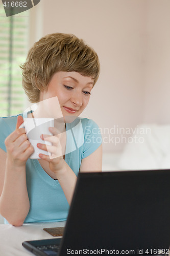 Image of young woman working on a laptop