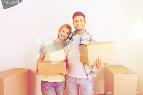 Image of smiling couple with big boxes moving to new home