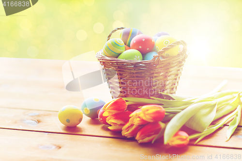 Image of close up of easter eggs in basket and flowers