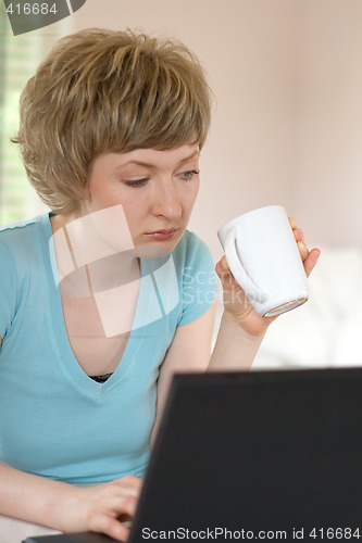 Image of young woman working on a laptop