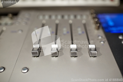 Image of music mixing console at sound recording studio