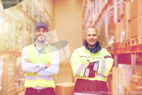 Image of men in uniform with boxes at warehouse