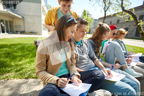 Image of group of students with notebooks at school yard