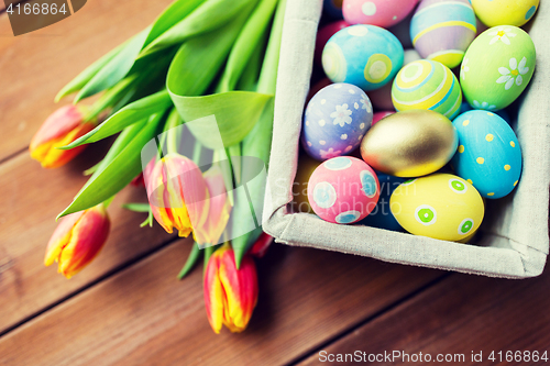 Image of close up of colored easter eggs and flowers