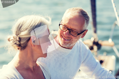 Image of senior couple hugging on sail boat or yacht in sea