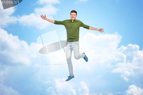 Image of smiling young man jumping in air