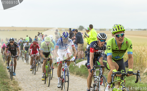 Image of The Peloton on a Cobblestone Road - Tour de France 2015