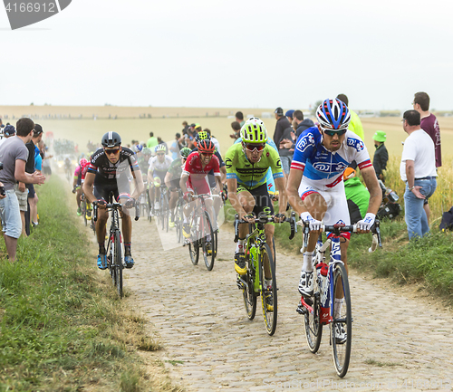 Image of The Peloton on a Cobblestone Road - Tour de France 2015