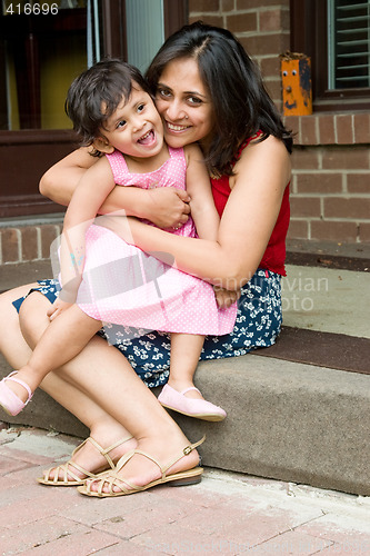 Image of Mother and daughter sitting at the doorstep