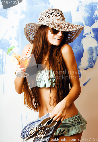 Image of cute bright woman in sunglasses and hat with cocktail in bikini in studio close up