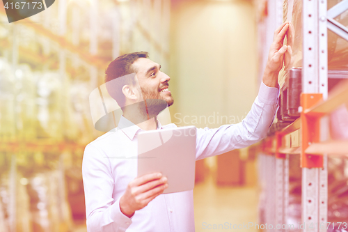 Image of happy businessman with tablet pc at warehouse