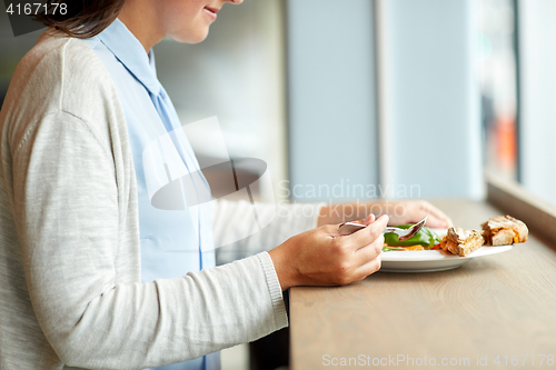 Image of woman eating gazpacho soup at restaurant