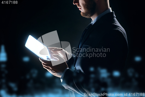 Image of close up of businessman with transparent tablet pc