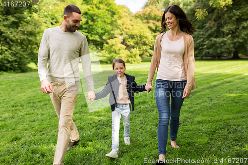 Image of happy family walking in summer park