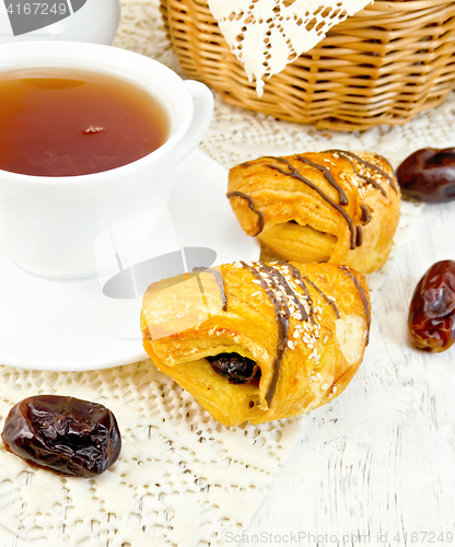 Image of Cookies with dates and tea in cup on board