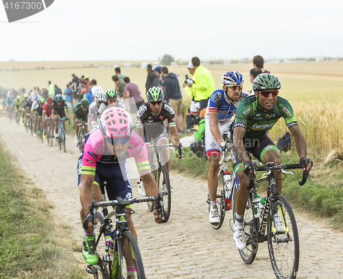 Image of The Peloton on a Cobblestone Road - Tour de France 2015