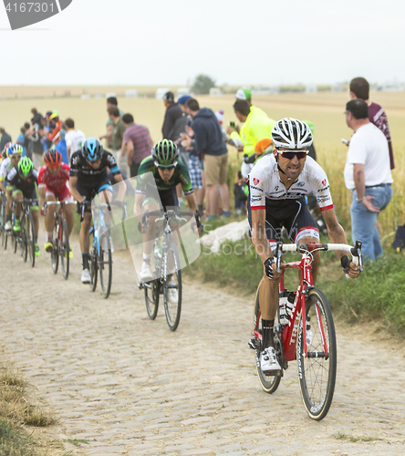 Image of The Peloton on a Cobblestone Road - Tour de France 2015