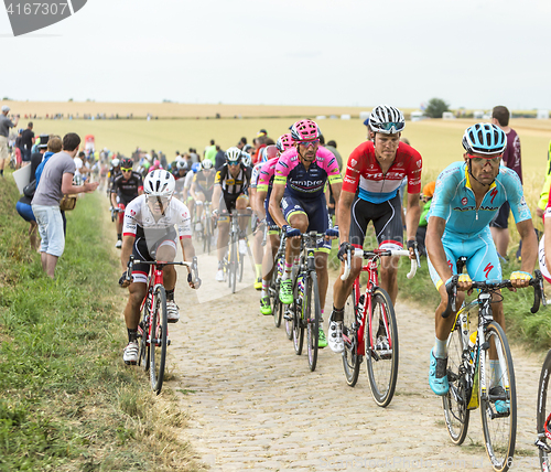 Image of The Peloton on a Cobblestone Road - Tour de France 2015