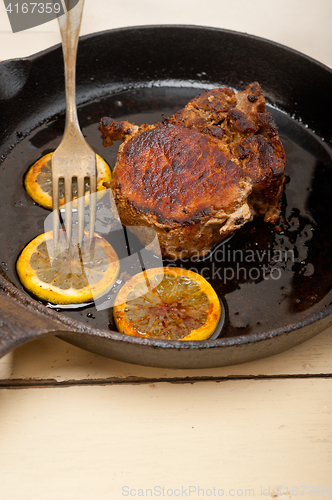 Image of pork chop seared on iron skillet