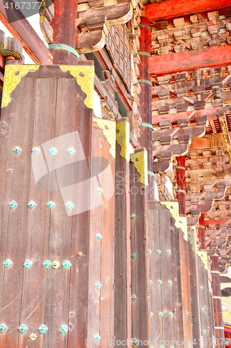 Image of Large wooden doors with golden decorations