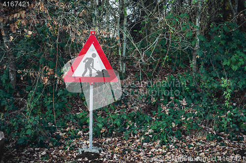 Image of Under construction sign with a digging worker